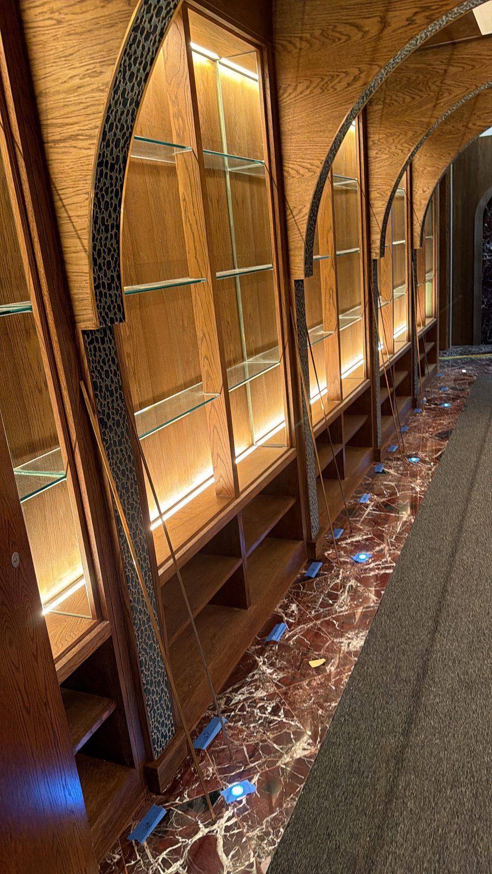 Bespoke arched oak joinery and glazed display cabinetry, fitted by Aretis Bespoke
